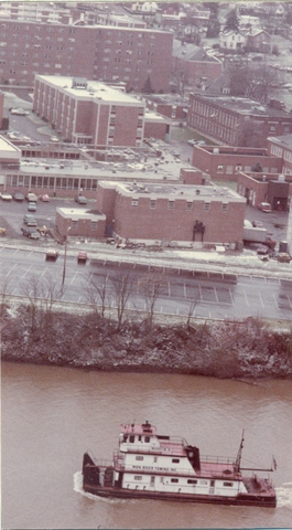 Campus from river with tugboat (1970s?)