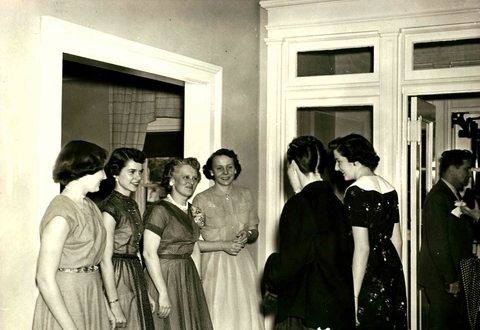 Ruth Harris greeting women