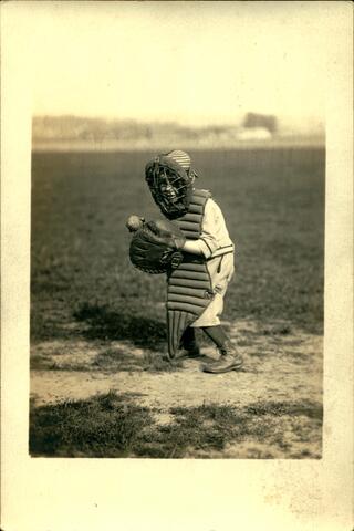 Child baseball player in catching equipment, Harrison Family Photos. 